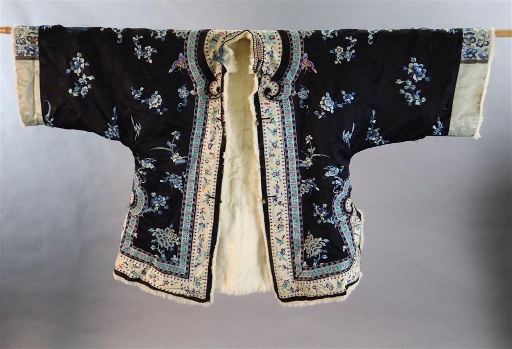 A Chinese black silk multi-coloured embroidered three quarter length winter jacket, late 19th century/early 20th century, length 90cm